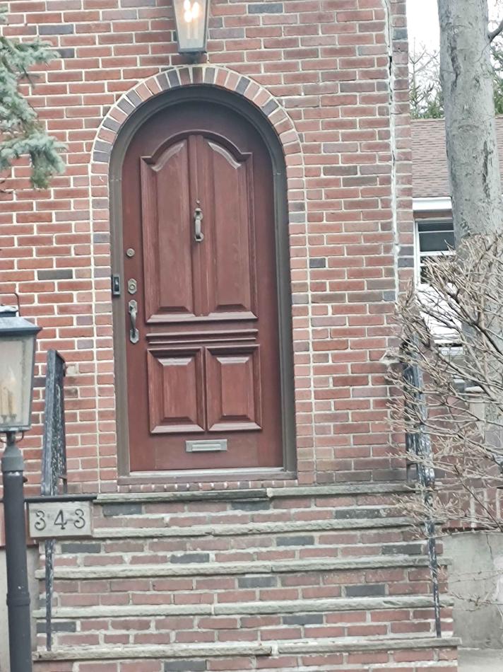 Custom arched front door installation by AB6 Carpentry