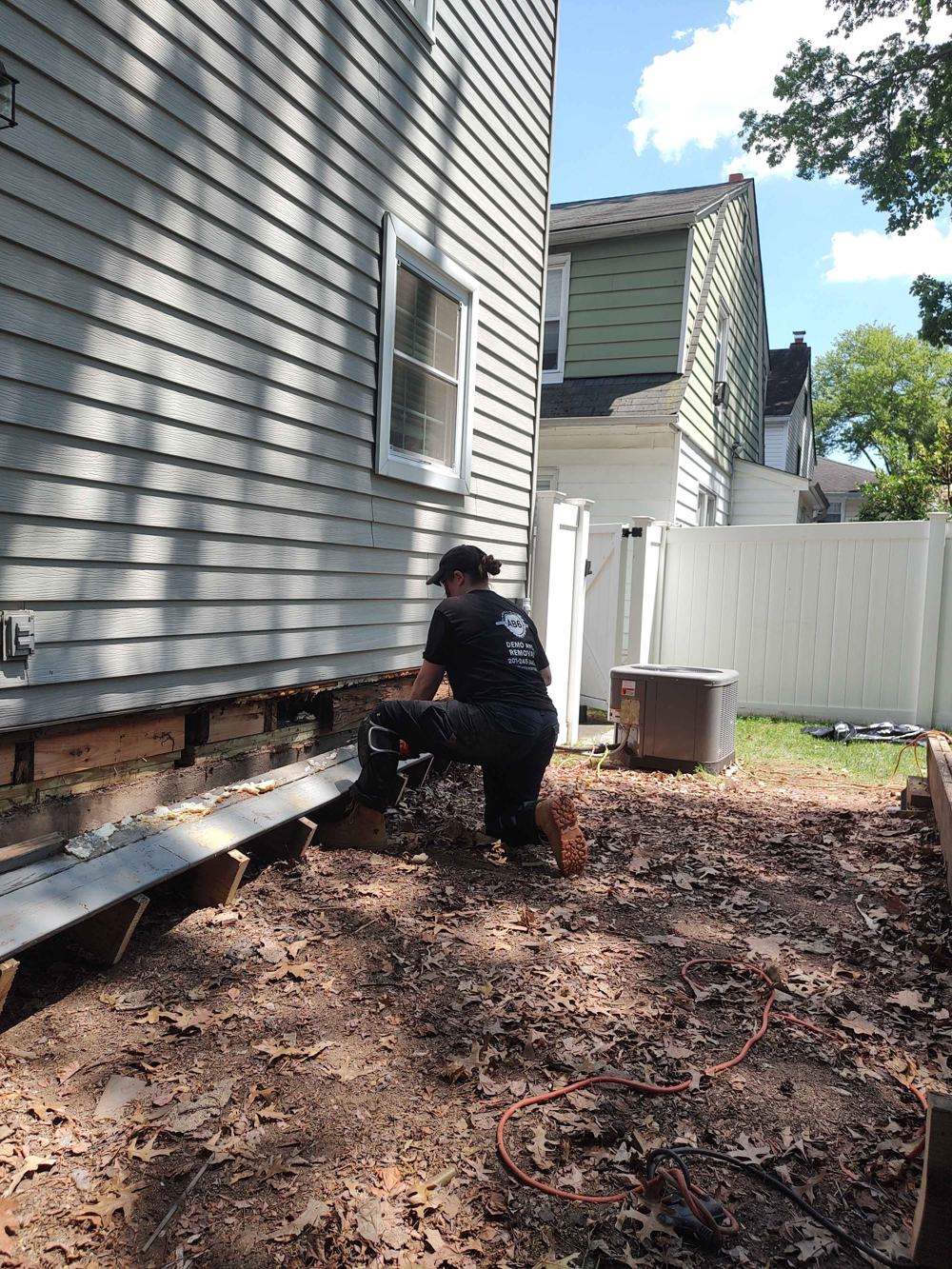 AB6 Demo and Removal — family-owned crew at work in a branded shirt